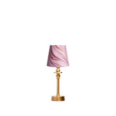 a lamp with a pink and gold shade on the base, sitting against a white background