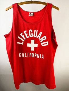 "Authentic 90s California Lifeguard red tank top, printed on a Signal Mega-Tee.  Some very small, pin-sized marks, otherwise wonderful condition... please see pictures. Marked Size: XL Length (Top of Collar to Bottom): 26\" Width (Pit to Pit): 23\"" 90s California, Sand Surfing, Red Tank Top, Military Cap, Red Tank Tops, Red Tank, Small Pin, Beach Vibes, Silhouette Projects