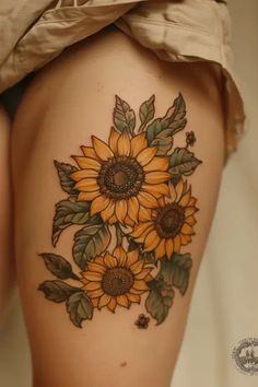 a woman's thigh with sunflowers on it