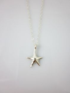 A sterling silver star charm hangs on a dainty sterling silver chain and closes with spring clasp. Simple and chic everyday jewelry. Charm measures: 16 x 10 mm Total length of necklace : 17 inches All components are sterling silver. All items are shipped in a gift box via registered mail. Thanks for looking. Please have a look at more items in the shop: http://smoketabby.etsy.com Sterling Silver Necklace With Starfish Charm, Star-shaped Charm Necklace With Lobster Clasp As Gift, Star-shaped Sterling Silver Jewelry With Lobster Clasp, Sterling Silver Starfish Necklace With Star Charm, Gift Star-shaped Charm Necklace With Lobster Clasp, Minimalist Starfish Charm Jewelry, Sterling Silver Starfish Charm Necklace, Sterling Silver Star Charm Necklace Nickel Free, Sterling Silver Star Charm Necklace For Everyday