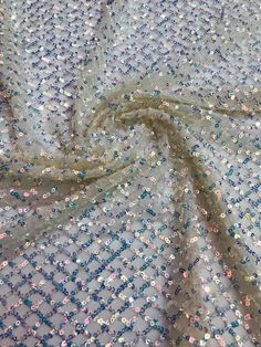 We offer a variety of fashion handmade fabric，those are widely use for wedding dress，garment and fashion cloth. we sell it by yard，our minimum order is 1 yards，and we always package it 15 yards for one roll，the width is about 130cm/50 inch Material ： tulle ,pearls, beads ,Rayon,polyester. Symmetrical embroidery floral pattern, with lovely flowers in the middle, scalloped border. You can also cut and use separately. Perfect for dress, tops, wedding veil. You can split the piece up and have one sc Fitted Sequined Embroidered Fabric For Summer, Spring Party Lace Sequin Fabric, Festive Party Sequin Lace Fabric, Sequin Net Party Dress, Sequin Net Dress For Party, Glamorous Net Dress With Sequins, Party Dress With Sequins On Net Material, Party Dress With Sequins On Net, Sequin Fabric With Lace Work For Festive Party