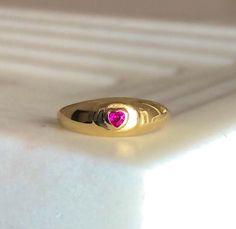 "\"Be Mine\" Dainty Pink Heart Stone Signet Ring with Ruby Cubic Zirconia Crystal. This ring shouts LOVE and PASSION in the most subtle way possible!💞 So simple and sensual ✨The PERFECT dainty LOVE Ring! Ways to Wear: Pinky finger and Index finger💞 Ruby Represents: Love, Energy, Passion, Power, and Zest of Life💖 Handmade Item 💕😊 ENJOY ! Material 18K-Gold Plated over Solid Sterling Silver Gemstone: Cubic Zirconia Lead & Nickel free Details Ruby Cubic zirconia (Red/Pink) Diamond cut stone Ring With Ruby, Pinky Finger, Ruby Heart, Gold Heart Ring, Heart Padlocks, Swarovski Crystal Hearts, Ring Ruby, Stamped Rings, Ring Heart