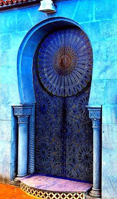 a blue building with an ornate door and window