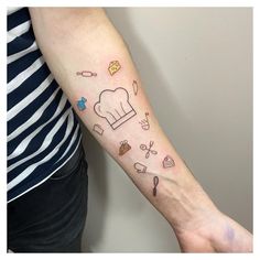 a person with a tattoo on their arm that has food and cooking related drawings all over it