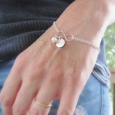 A polished infinity symbol is centered on a double strand of sterling silver chain & adorned with a freshwater pearl and the initial of your choice. Bracelet adjusts from 7 to 8 inches. 3 font choices available! Silver bracelet shown is solid sterling silver. Gold bracelet features 14K gold filled findings with a polished solid bronze infinity charm. >>To enter to my shop<< http://www.kgarnerdesigns.etsy.com Please contact me PRIOR TO PURCHASE if you are ordering on a deadline. I Silver Pearl Bracelet With Pearl Charm For Mother's Day, Dainty Personalized Silver Pearl Bracelet, Adjustable Sterling Silver Pearl Charm Bracelet, Personalized Silver Dainty Pearl Bracelet, Silver Pearl Bracelet For Mother's Day, Hypoallergenic Sterling Silver Pearl Bracelet, Nickel-free Sterling Silver Pearl Bracelet, Nickel-free Sterling Silver Pearl Bracelet Gift, Adjustable Sterling Silver Pearl Bracelet For Anniversary