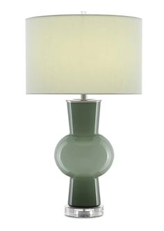 a green table lamp with a white shade on the base and a light in front of it