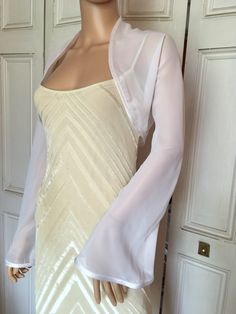 This is a beautiful hand made white chiffon shrug with long FLARED sleeves ideal for weddings or special occasions. It can also be worn with casual wear. It has a silver edging. It can be made in any size from 8 to 24 (UK sizes). It is made in the UK. It is normally sent out to you within 5 days, but I am very happy to make your order a priority if you need it urgently. Just let me know the date needed by. Postage is free in the UK! International postage is £9. I am happy to exchange items or re Dress Covers Shoulder, Dress Cover Up Formal Jacket, Bolero With Dress, Vigilante Costume, Dress Cover Up Formal, Prom Dress Jacket, Shrug Sleeves, Chiffon Shrug, Dress With Shrug