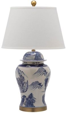 a blue and white table lamp with a shade on the top that is turned off