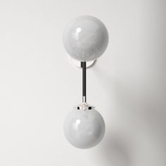 two white balls are hanging from the wall