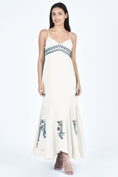 A luxurious blend of bohemian and vintage charm, this midi dress is crafted from 100% cotton. Featuring an empire waist, delicate spaghetti straps, a flounce tulip skirt, and intricate grapevine and floral embroidery. Elegant Summer Embroidered Dress, Elegant Summer Embroidered Dress With Hem Detail, Elegant Fitted Maxi Dress With Embroidered Hem, Elegant Summer Embroidered Cotton Dress, Elegant Embroidered Cotton Dress For Summer, Embroidered Cotton Dress With Spaghetti Straps, Elegant Floral Embroidered Maxi Dress For Vacation, Elegant Cotton Maxi Dress With Spaghetti Straps, Elegant Spring Maxi Dress With Embroidered Hem