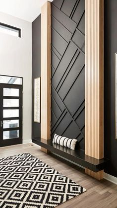 a black and white room with wood accents on the walls, rugs and artwork