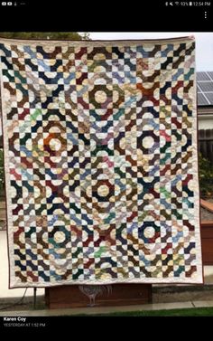 a large quilt hanging on the side of a building