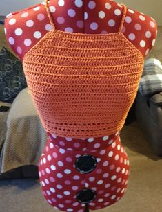 a mannequin made out of red and white polka dot fabric with buttons on it