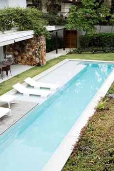 an empty swimming pool in the middle of a yard with steps leading up to it