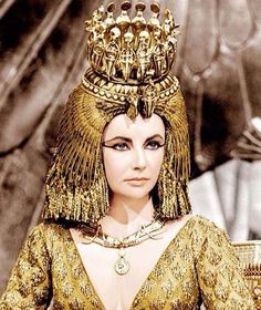 an egyptian woman wearing gold jewelry and headdress in a scene from the film