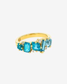 Kalan By Suzanne Kalan Nadima Blend Aqua Ombre Ring in 14k yellow gold Emerald Cut Multi-stone Topaz Ring In Fine Jewelry Style, Fine Jewelry Multi-stone Topaz Rings, Fine Jewelry Topaz Multi-stone Rings, Fine Jewelry Multi-stone Topaz And Diamond Ring, Fine Jewelry Diamond Multi-stone Topaz Ring, Modern Multi-stone Baguette Cut Jewelry, Fine Jewelry Blue Topaz Cluster, Modern Multi-stone Baguette Cut Rings, Fine Jewelry Blue Topaz Rings With Single Cut Diamonds