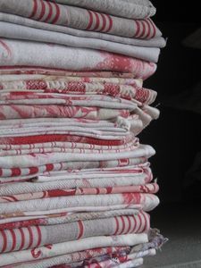 a stack of folded towels sitting on top of each other