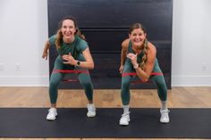 two women are doing exercises on a mat