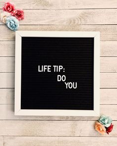 a white frame with the words life tip do you written on it next to flowers