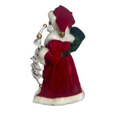 a santa clause figurine holding a christmas tree ornament