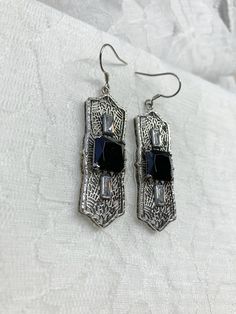 "Black Cubic Zirconia Earrings Square Peg Design#E63 Custom Made About 12 months ago I found a lovely Art Deco brooch and fell in love with the design. Fashioned in the design of the brooch, I now offer these lovely Antique reproduction earrings in sterling silver (matching pendant also available for sale in my store). The 3ct simulated black cubic zirconia gemstone is 10mm in L & W (3/8th\"). The 2 baguette CZ gems are 6mm x 3mm. The pendant is 1 3/4 inches long, it is just shy of 5/8th\" a Black Art Deco Earrings For Evening, Black Diamond Cubic Zirconia Earrings As Gift, Gift Black Diamond Drop Earrings, Black Diamond Drop Earrings Gift, Silver Filigree Earrings For Party, Black Cubic Zirconia Dangle Jewelry, Black Cubic Zirconia Jewelry With Matching Earrings, Black Cubic Zirconia Earrings For Evening, Elegant Black Plug Earrings As Gift