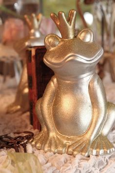 a gold frog figurine sitting on top of a bed