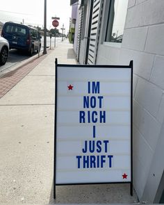 a sign that says i'm not rich i just thrift on the sidewalk