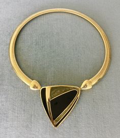 "You are looking at a truly exquisite VINTAGE TRIFARI MODERNIST, ART DECO STYLE, KUNIO MATSUMOTO ERA, BLACK and SILVER-COLOURED ENAMEL AND GOLD METAL OMEGA SNAKE CHAIN PENDANT COLLAR NECKLACE, SIGNED, Circa 1980's. THIS COLLAR NECKLACE IS EXTREMELY BOLD, EYE-CATCHING AND GORGEOUS SUPER RARE MINT, IN EXCELLENT, LIKE NEW CONDITION, IT HAS NEVER BEEN USED THIS NECKLACE WITH AN ART DECO INSPIRED BLACK AND SILVER ENAMEL STATION AND SUPER SHINY OMEGA CHAIN IS EXTRAORDINARILY BEAUTIFUL AND SCULPTURAL T Vintage Jewelry With Unique Design For Formal Occasions, Vintage Formal Jewelry With Unique Design, Vintage Black Enamel Necklaces For Evening, Vintage Black Enamel Necklace For Evening, Vintage Black Enamel Necklaces For Formal Occasions, Vintage Black Enamel Necklace For Formal Occasions, Designer Metal Necklaces For Formal Occasions, Modernist Art, Vintage Runway