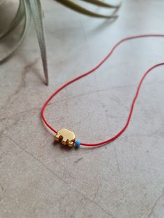 🌙 Handcrafted 14k gold plated dainty adjustable red string necklace 🌙 All materials used are tarnish free and durable 🌙 Best gift for your friends and family or just for yourself 🌙 Regular shipping takes approximately 10-15 business days depending on your country. Express shipping takes 3-5 business days. Please choose express shipping if you want to receive your package faster 🌙 I do offer combined shipping. Please feel free to contact me for custom orders and combined shipping orders 🌙 Although my products are durable and tarnish free, you better keep them away from excessive water and chemicals, perfumes etc. 🌙 For more jewelries don't forget to check my store: https://www.etsy.com/shop/MiniMoonDesign Gold Jewelry With Adjustable Cord For Good Luck, Cord Choker, String Necklace, Choker Jewelry, Red String, Personalized Gift Wrap, Elephant Charm, Pretty Necklaces, Bead Store