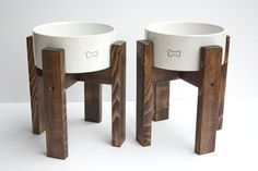 two wooden stools with white bowls on them