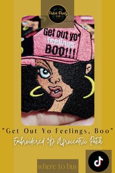 a person holding up a pink hat with the words get out yo feelings, boo