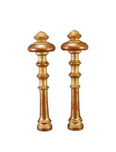 two golden candlesticks sitting next to each other