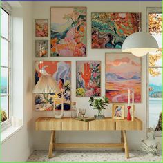 a room with paintings on the wall and a table in front of it next to a window