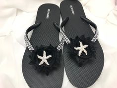 This beautiful flip flops is wrapped with black satin ribbon, and adorned with a black shabby chic chiffon flower with a silver starfish in the center. Ribbon color is black, if you are needing other colors of ribbon or decoration please contact me and will be happy to accommodate you! All flip flops are handmade to order and the production time is 5-7 business days and then please allow additional time for shipping.  On a larger order please contact me. Amazing for beach, weddings, flower girl Black Shabby Chic, Bridal Flip Flops, Silver Flip Flops, Beach Wedding Sandals, Wedding Flip Flops, Sandals Wedding, Satin Noir, Shabby Flowers, Chiffon Flowers