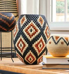 two vases sitting on top of a wooden table