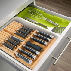 an organized drawer with knives and other kitchen utensils