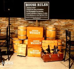 barrels stacked on top of each other in front of a sign that says house rules