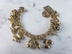 "A WOMENS VINTAGE ESTATE 14k GOLD CHARM BRACELET WITH 17 CHARMS. THE BRACELET WEIGHS 54.8g, AND MEASURES 7 1/2\" LONG. MOST OF THE CHARMS ARE MARKED 14K EXCEPT FOR A FEW OF THEM. THE EIFEL TOWER IS MARKED \"750\". THOSE THAT ARENT MARKED HAVE BEEN TESTED AND ARE GUARANTEED TO BE AS DESCRIBED. ANY QUESTIONS PLEASE DON'T HESITATE TO ASK. THIS MAKES A GREAT GIFT FOR THAT SOMEONE SPECIAL. BE SURE TO CHECK OUT SOME OF MY OTHER GREAT ITEMS UP FOR SALE. THANK YOU." Gold Charm Bracelet Vintage, Vintage Charm Bracelet, Gold Charm Bracelet, Fashion Portfolio, Fine Jewelry Bracelets, New People, Gold Charm, Charm Bracelets, Vintage Charms