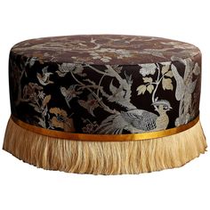 a black and gold hat with a bird on it