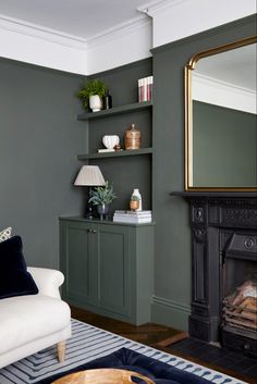 a living room filled with furniture and a fire place in front of a wall mounted mirror