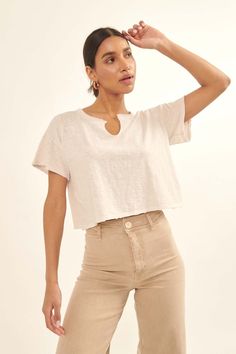 A mineral washed, slub knit t-shirt. Distressed, raw-edge detailing at neckline, cuffs, and hem. Split neckline. Short sleeves. Drop shoulder. Cropped length. Loose fit. 100% Cotton. Imported. Designed in LA. Model wears size S. Summer Linen Tops With Frayed Hem, Spring Linen Tops With Frayed Hem, Summer Washed Linen Tops, Casual Cropped Top With Frayed Hem, Spring Soft-washed Cropped Tops, Casual Cotton Cropped T-shirt With Scoop Neck, Spring Cotton Cropped T-shirt With Scoop Neck, Washed Cotton Cropped T-shirt With Short Sleeves, Washed Cotton Cropped T-shirt Relaxed Fit