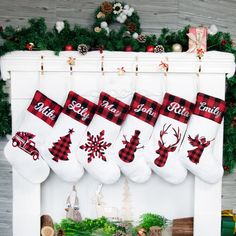 christmas stockings hanging from a fireplace with red and white plaid designs