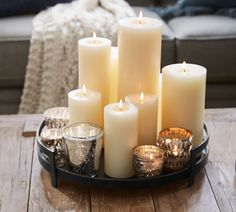 a tray filled with candles on top of a wooden table