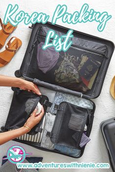 an open suitcase sitting on top of a table with shoes and other items in it