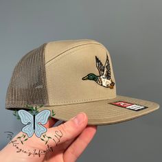 Experience the great outdoors in style with our Mallard Duck Embroidered Richardson 168 Trucker Cap. The stunning embroidered design adds a touch of wildlife to your wardrobe. The 7-panel construction and adjustable fit provide comfort for all-day wear. Perfect for any avid nature enthusiast! 60/40 cotton/polyester, twill 100% polyester mesh back Structured, seven-panel, Hi pro profile Flat bill Adjustable snapback closure Richardson Hats, Rhinestone Hoodie, Nature Enthusiast, Nurse Hat, Mallard Duck, Easter Outfit, Thanksgiving Outfit, Mallard, Cool Hats