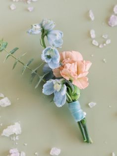 a bouquet of flowers sitting on top of a table covered in confetti flakes