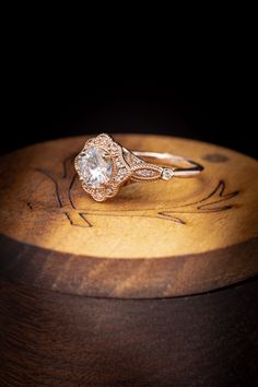 a diamond ring sitting on top of a wooden box