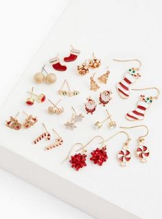 Put the jolly in your holly this holiday season with this set of earrings that are perfect for dressing-up that festive outfit or make for a great gift. Set of 15 . Post and hook backs. Base metals. Imported. The best plus size women's gold-tone red & white holiday earrings set - of 15 sets in multi. Torrid is your destination for cozy fall and winter clothes to keep you warm and comfortable. Torrid is your destination for plus size SALE > CLEARANCE merchandise. Holiday Earrings, Jewelry Picture, Holiday Earring, Winter Clothes, Christmas Jewelry, Cozy Fall, Base Metal, Festival Outfits, Earrings Set