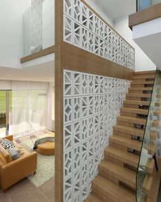 a living room filled with furniture next to a stair case