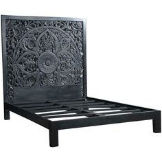 a black bed frame with intricate carvings on the headboard and foot board is shown in front of a white background